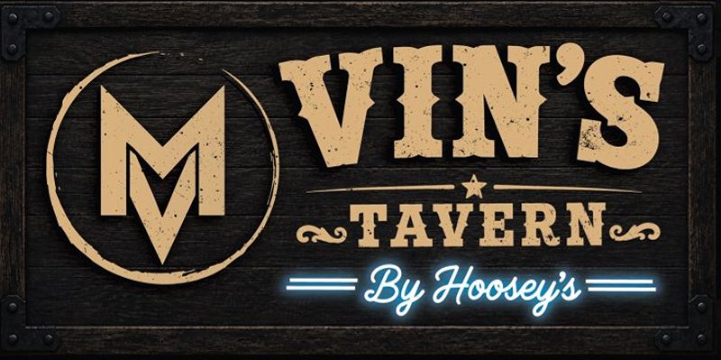 Vin’s Tavern black wooden sign with vintage lettering.