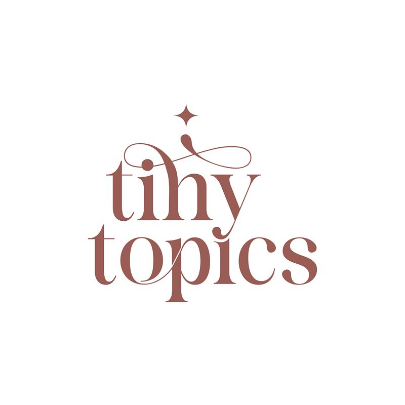 Tiny Topics logo with elegant brown serif lettering and decorative details.